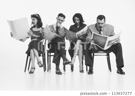 Group of four people, men and women in retro-style clothes sitting on chair and reading newspapers, journals with shocked face on white background. Monochrome image. Group of four people, men and women in retro-style clothes sitting on chair and reading newspapers, journals with shocked face on white background. Monochrome image. 113657277