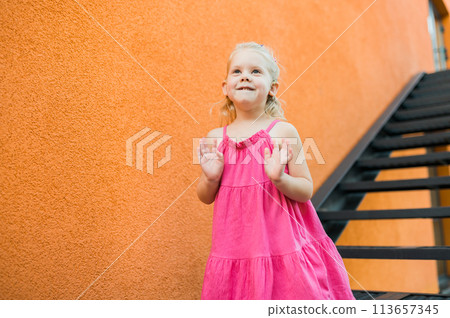 Child walks with cochlear implant system. Installation cochlear implant on child girl ear for restores hearing. Kid hears after hear return to normal. Diversity inclusion concept. Copy space 113657345
