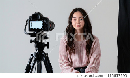 Girl video blogger in front of the camera. Vlog 113657593