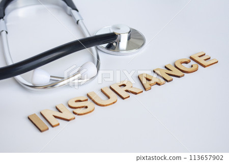 Doctor's stethoscope with Insurance text on white background. Life insurance concept Doctor's stethoscope with Insurance text on white background. Life insurance concept 113657902