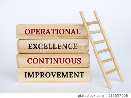 Operational Excellence and Continuous Improvement text on wooden blocks with wooden toy ladder 113657906