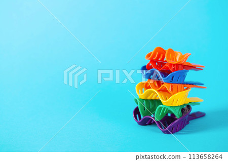 Multi-colored dental spoons for taking an impression of the dental jaw on a blue background. Making an impression of the jaw for braces and dental prosthetics, close-up. Copy space for text 113658264