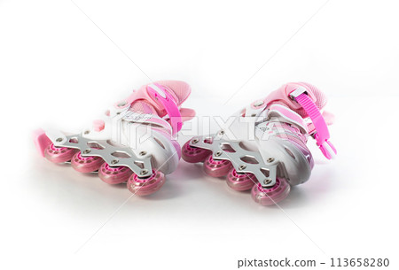 Pink girlish roller skates on a white background, isolate. Close-up Pink girlish roller skates on a white background, isolate. Close-up 113658280