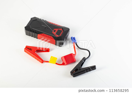 Modern power bank with clips for starting a car engine, white background, close-up 113658295