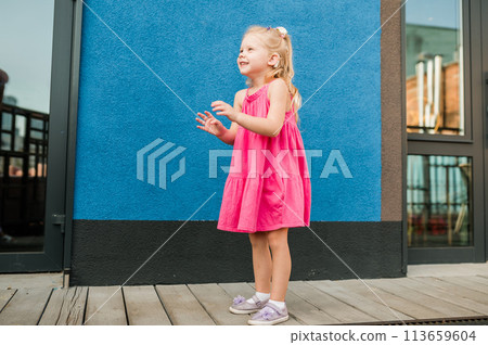 Child girl with hearing aids and cochlear implants having fun outdoor speak and playing. Copy space. Diversity inclusion concept. Child girl with hearing aids and cochlear implants having fun outdoor speak and playing. Copy space. Diversity inclusion concept. 113659604