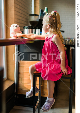 Funny baby with cochlear implant spend time cafe. Hearing aid and medicine innovating technology and diversity inclusion concept. Funny baby with cochlear implant spend time cafe. Hearing aid and medicine innovating technology and diversity inclusion concept. 113659635