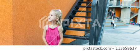 Banner child have fun with cochlear implant hearing aid in summer city. Inclusion and modern technologies for treating hearing loss. Copy space and empty space for text 113659637