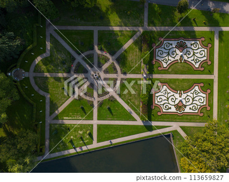 A beautiful quadcopter flight over the castle, the park and the water moat around the castle. A beautiful park in English style. A beautiful quadcopter flight over the castle, the park and the water moat around the castle. A beautiful park in English style. 113659827