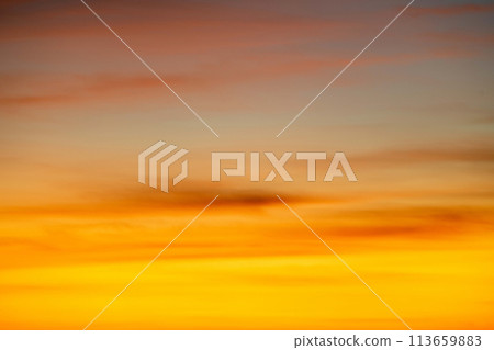 The dramatic colors of the sunset in the sky gradient from blue to orange. The dramatic colors of the sunset in the sky gradient from blue to orange. 113659883