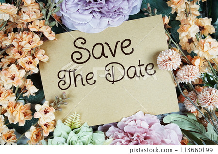 Save the Date typography text with flower decorated on wooden background 113660199