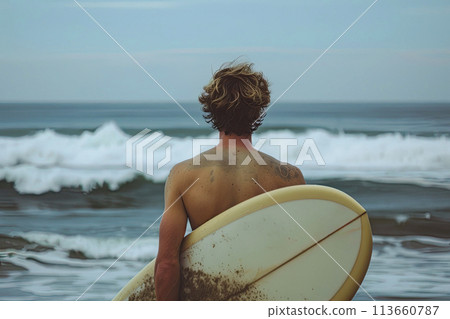 Surfer looks at the ocean while holding his surfboard at the beach. Ai generative 113660787