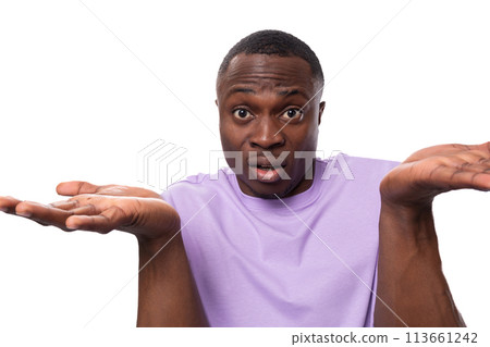 a young friendly well-groomed American guy dressed in a cotton T-shirt shrugs his shoulders a young friendly well-groomed American guy dressed in a cotton T-shirt shrugs his shoulders 113661242