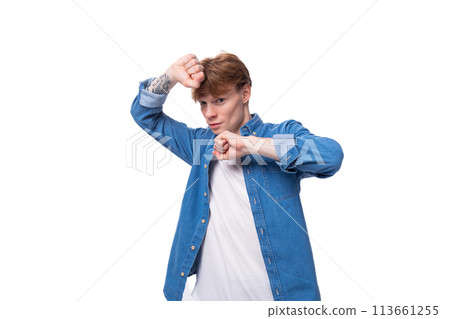 young man with red hair wearing a blue shirt over a white t-shirt 113661255