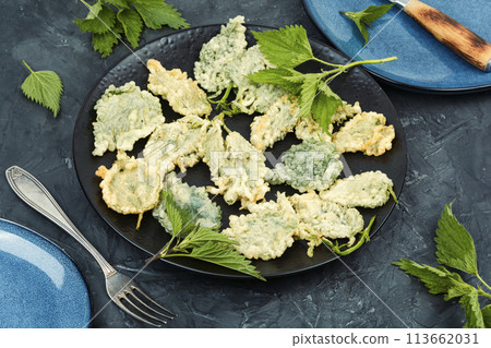 Nettle leaves in batter, vegetarian food. 113662031