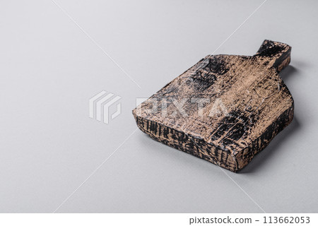 Empty wooden cutting board on gray textured concrete background Empty wooden cutting board on gray textured concrete background 113662053