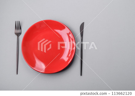 An empty plate on a gray concrete background with copy space 113662120
