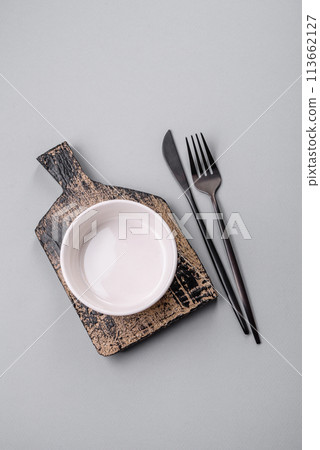 An empty plate on a gray concrete background with copy space An empty plate on a gray concrete background with copy space 113662127