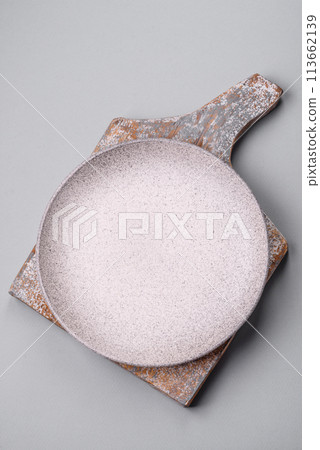 An empty plate on a gray concrete background with copy space 113662139