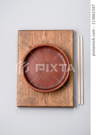 An empty plate on a gray concrete background with copy space 113662387