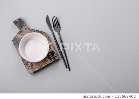 An empty plate on a gray concrete background with copy space 113662408