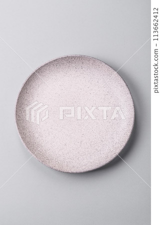 An empty plate on a gray concrete background with copy space 113662412