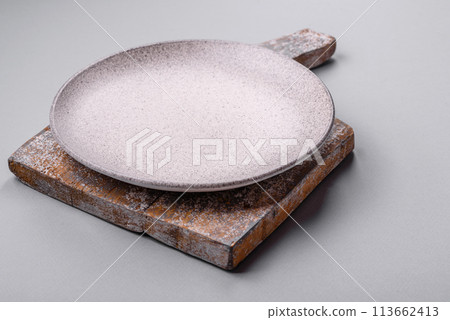 An empty plate on a gray concrete background with copy space An empty plate on a gray concrete background with copy space 113662413
