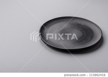 An empty plate on a gray concrete background with copy space 113662416