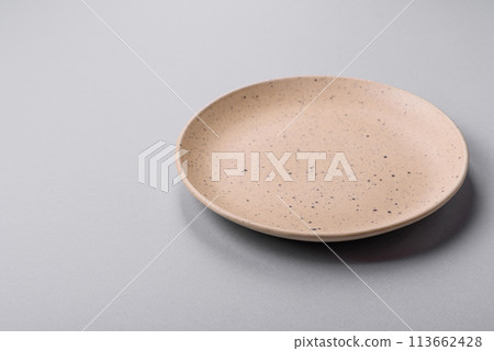 An empty plate on a gray concrete background with copy space 113662428