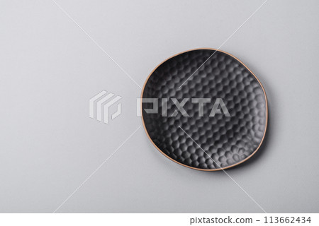 An empty plate on a gray concrete background with copy space An empty plate on a gray concrete background with copy space 113662434