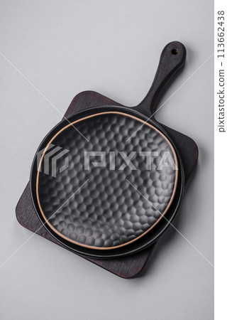 An empty plate on a gray concrete background with copy space 113662438