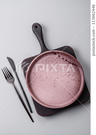 An empty plate on a gray concrete background with copy space 113662446
