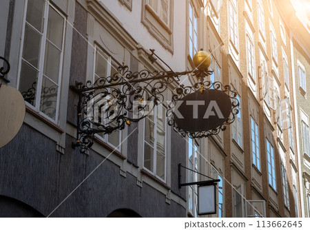 Salzburg, Austria, August 15 2022. The characteristic signs of the shops in the historic center, made of metal, have a particular vintage charm. 113662645