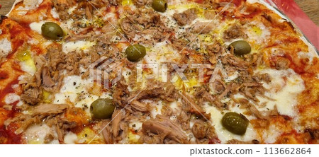 Gourmet tuna and olive pizza on wooden table Gourmet tuna and olive pizza on wooden table 113662864