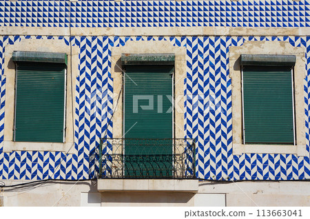 Geometric Pattern of Azulejo Tiles on Wall of a Old Building in Lisbon, Portugal. Geometric Pattern of Azulejo Tiles on Wall of a Old Building in Lisbon, Portugal. 113663041
