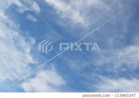Airplane trail in the blue sky with white clouds - travel background Airplane trail in the blue sky with white clouds - travel background 113663247