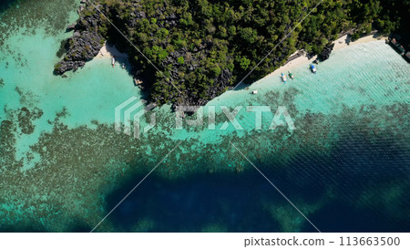 Tropical island with beach rocks coral reef Tropical island with beach rocks coral reef 113663500