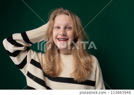 Woman With Blonde Hair Wearing a Striped Sweater 113663948