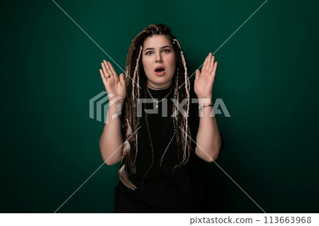 Woman With Dreadlocks Standing In Front Of Green Background 113663968