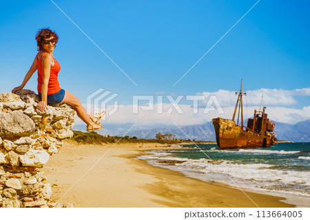 Tourist woman on beach enjoying vacation Tourist woman on beach enjoying vacation 113664005