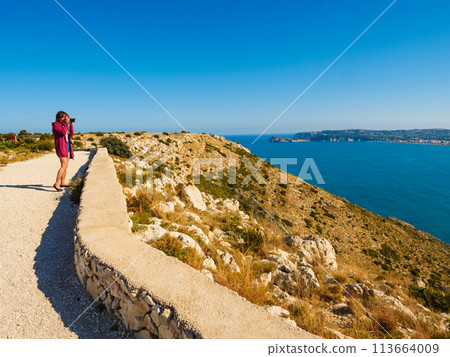 Tourist take photo on Cape San Antonio 113664009