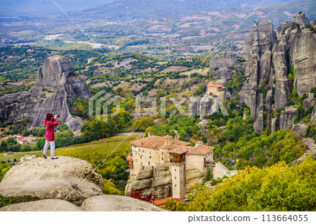 Woman take photo from Meteora monastery Woman take photo from Meteora monastery 113664055