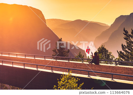 Tourist enjoy fjord view on Stegastein viewpoint Norway Tourist enjoy fjord view on Stegastein viewpoint Norway 113664076