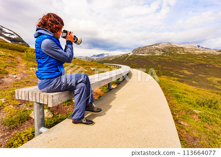 Woman on Vedahaugane rest stop, Norway Woman on Vedahaugane rest stop, Norway 113664077