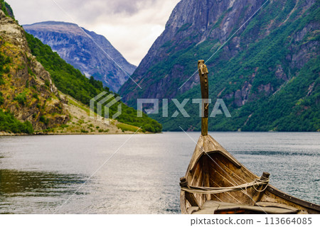 Old viking boat on fjord shore, Norway Old viking boat on fjord shore, Norway 113664085