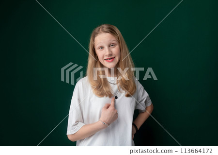 Woman Standing in Front of Green Wall 113664172