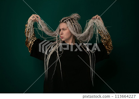 Woman With Dreadlocks Standing in Front of Green Background Woman With Dreadlocks Standing in Front of Green Background 113664227