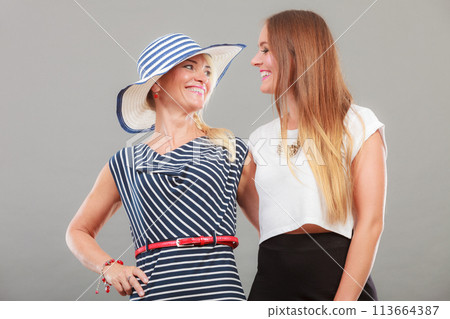 Fashionable mother and daughter posing together 113664387