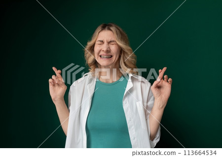 Woman With Eyes Closed and Hands Raised 113664534