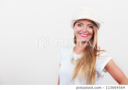 Woman wearing white top and light sun hat Woman wearing white top and light sun hat 113664564