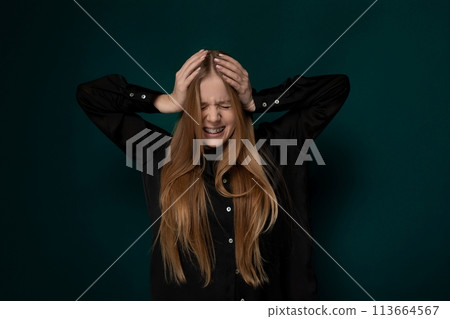 Woman With Long Red Hair Holding Hands to Head Woman With Long Red Hair Holding Hands to Head 113664567
